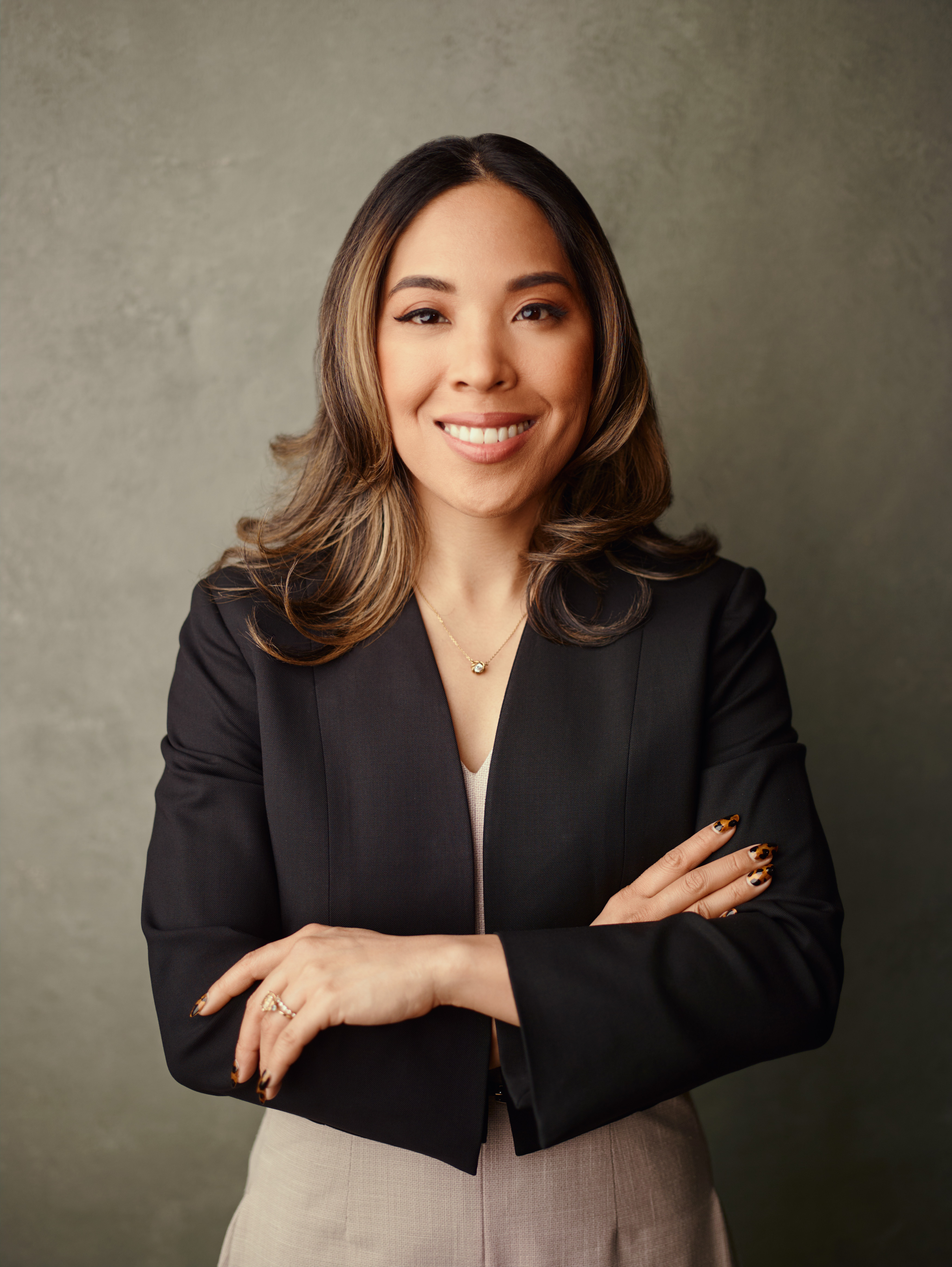 Charlene Platon, arms crossed in a dark blazer — career coaching